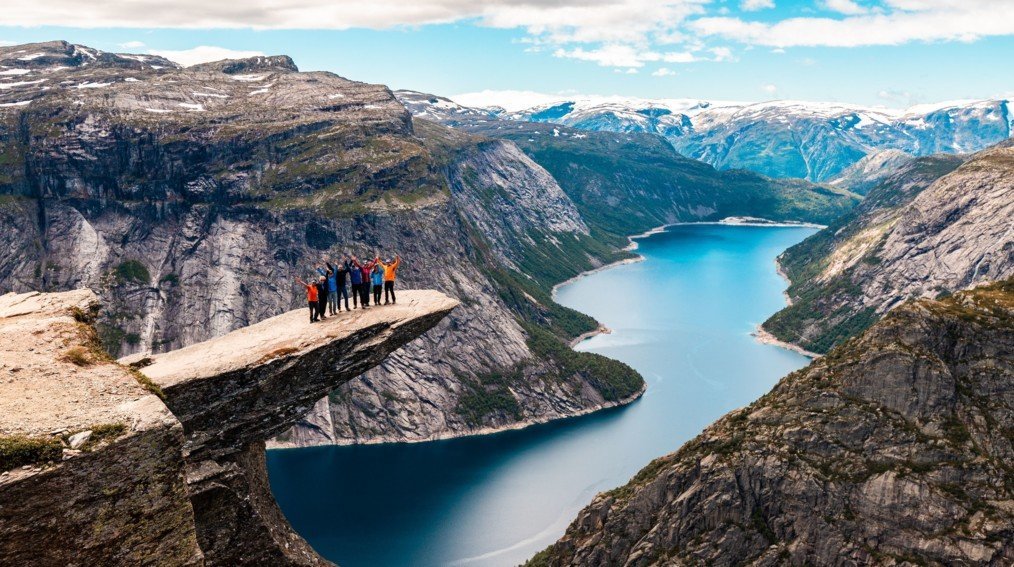 A dramatic Norwegian fjord with steep cliffs and calm water at sunset